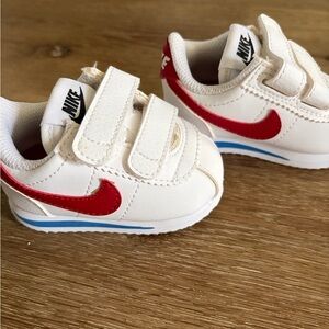 Nike Kids White Sneakers with Red Swoosh and Blue Stripe